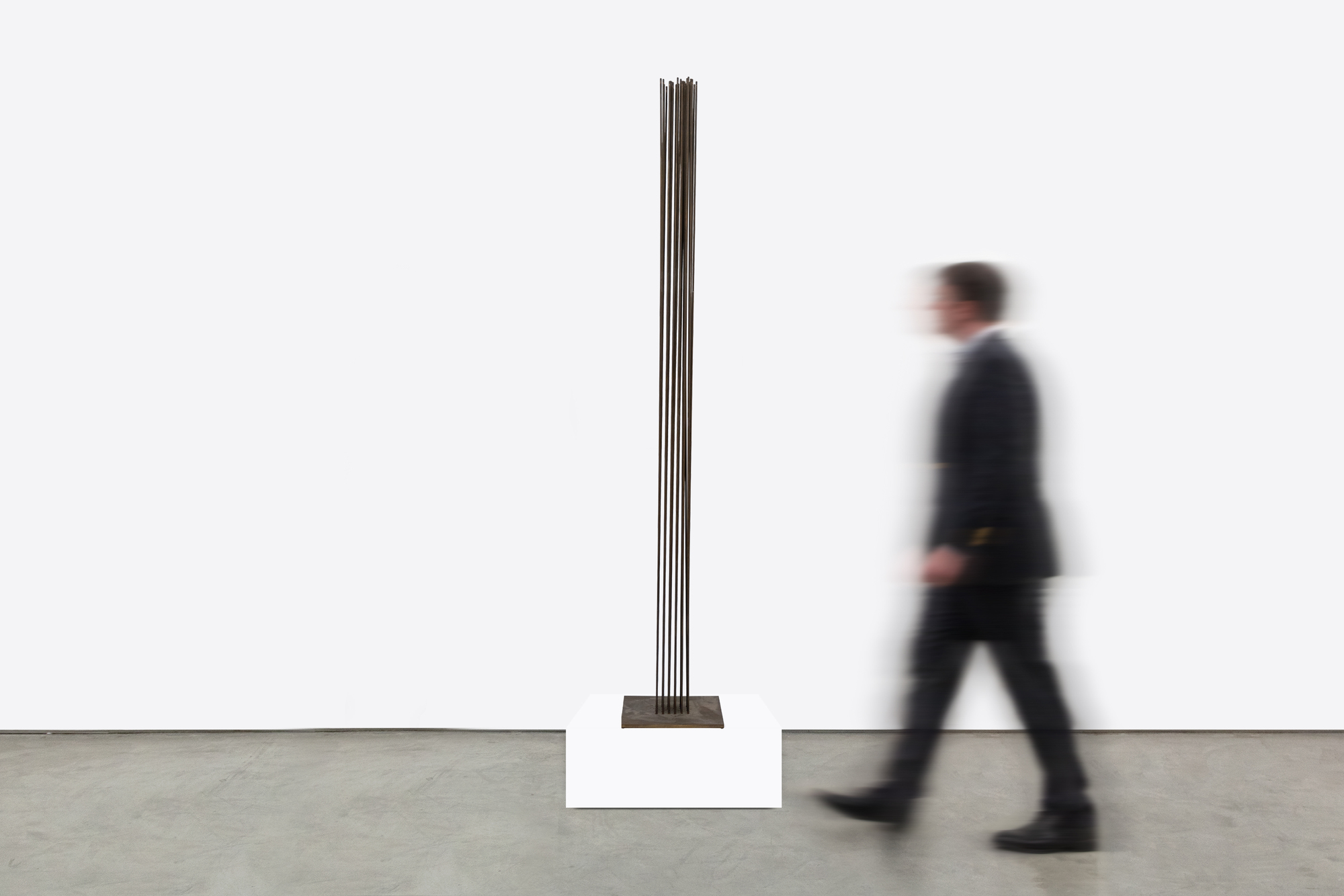 <div><font face=Calibri size=3 color=black>Standing at an impressive 103 inches, this elegantly spare “Sonambient” sculpture by Harry Bertoia allows us to marvel at one of the finest artisans of his generation. This piece, the tallest in the series currently available here at Heather James Fine Art, features a precise arrangement of 36 slender tines in a 6 x 6 grid. This arrangement's uniformity and symmetry are visually captivating and crucial for the sculpture's acoustic properties. The rods, austere and uncapped by finials, have an aged patina with copper undertones, suggesting Bertoia's use of copper or a similar alloy known for its resonant qualities and distinctive coloration. Given the outstanding length of these rods, the attachment method is particularly noteworthy. Bertoia meticulously inserted each rod into individual holes in the base plate using precision drilling and securing techniques such as welding that ensured the rods were firmly anchored and stable, maintaining the structural integrity essential for consistent acoustic performance.</font></div>
<br>
<br><div> </div>
<br>
<br><div><font face=Calibri size=3 color=black>Beyond his uncompromising nature, Bertoia's work draws significant inspiration from natural elements. This sculpture's tall, slender rods evoke images of reeds or tall grasses swaying gently in the wind. This dynamic interaction between the sculpture and its environment mirrors the movement of plants, creating an immersive, naturalistic experience. Yet when activated or moved by air currents, the rods of this monumental work initiate metallic undertones that confirm its materiality without betraying its profound connection to the natural world.</font></div>
<br>
<br><div><font face=Calibri size=3 color=black>Integrating technical precision and natural inspiration depends on exacting construction that ensures durability and acoustic consistency, while its kinetic and auditory nature imbues the piece with a sense of vitality. This fusion invites viewers to engage with the sculpture on multiple sensory levels, appreciating its robust craftsmanship and evocative, naturalistic qualities. Bertoia's ability to blend these elements results in a work that is both a technical marvel and a tribute to the beauty of the natural world.</font></div>