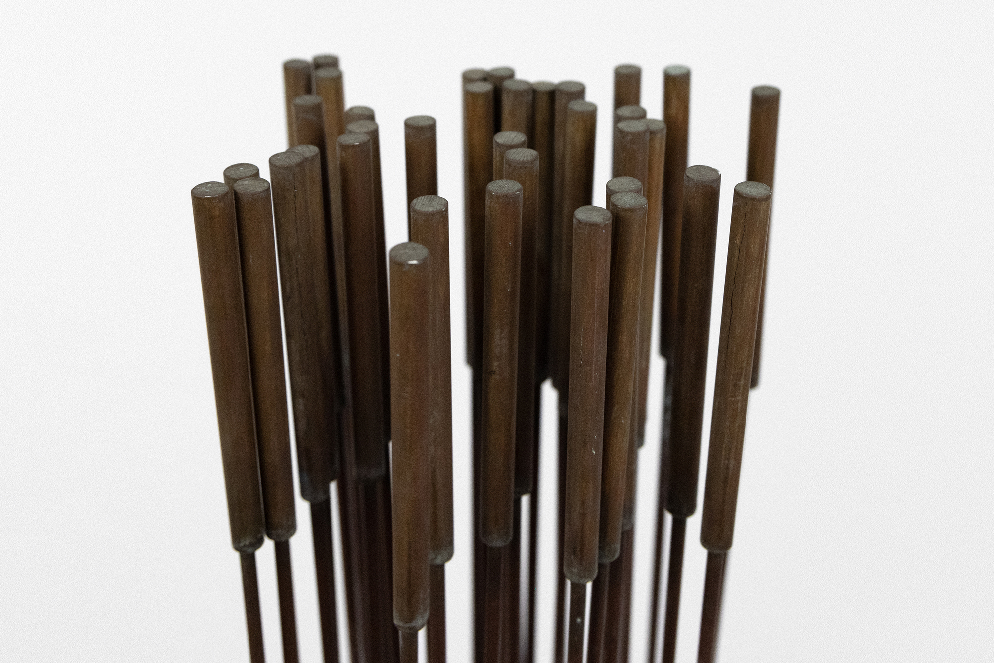 <div><font face=Calibri size=3 color=black>Harry Bertoia’s “Sonambient” sculptures are a mesmerizing blend of art, sound, and science, and this 36-tine piece is a quintessential example of his innovative genius. Meticulously crafted with 36 rods aligned in a precise six-by-six configuration on a square base, this 77-inch-tall work embodies the harmonious intersection of visual beauty and auditory wonder.</font></div>
<br>
<br><div> </div>
<br>
<br><div><font face=Calibri size=3 color=black>Made from beryllium copper, a material favored by Bertoia for its superior acoustic properties and aesthetic appeal, the rods have developed a rich walnut-like patina over time. This patina adds to the sculpture’s visual allure, enhancing its historical and artistic value, and reflects a natural aging process that the artist himself, a naturalist, would have admired. When activated by touch or the movement of air, the rods produce a perceptible, fixed note accompanied by a range of ethereal tones, transforming the sculpture from a static object into a dynamic, multisensory experience. The long, swaying motion of the tall rods, reminiscent of the undulating desert grasses that inspired the artist initially, adds a captivating visual dimension. The cattail-like finials further evoke natural forms, underscoring Bertoia’s inspiration derived from the natural world.</font></div>
<br>
<br><div> </div>
<br>
<br><div><font face=Calibri size=3 color=black>Bertoia’s 36-tine “Sonambient” sculpture is more than a visual masterpiece; it profoundly explores sound, material, and participatory interaction. It exemplifies Bertoia’s belief in art as an immersive and evolving experience, where each encounter offers discoveries and sensations. Through this work, Bertoia has created a timeless piece that continues to captivate and inspire, highlighting his artistic vision's enduring power and deep connection to nature’s spiritual qualities.</font></div>