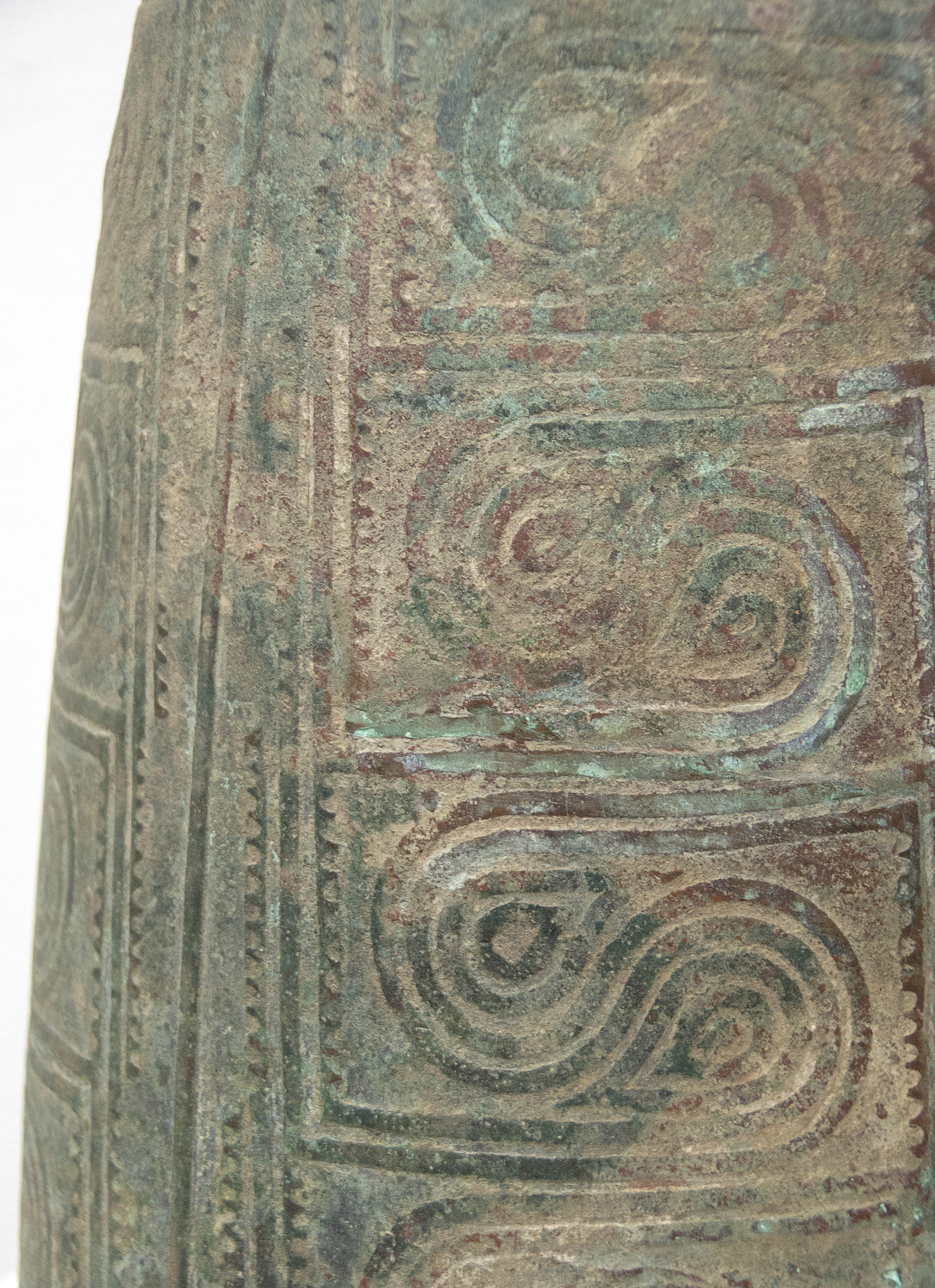 This well preserved bell is one of the largest known bronzes from the Southeast Asian Bronze Age, generally named after the Dongson site in North Vietnam.  The swirling band design is finely and crisply cast. Dongson bronze drums were also reported in South China, Thailand, Laos, West Malaysia, and Indonesia and as Far East as Western Iranian Java. 
<br>
<br>The Dong Son culture is a Bronze age culture including all of southeast Asia and into the Indo-Malaya Archipelago from about 1000 to 1 BC. Centered on the Red River Valley of Vietnam, the Dong Son were sophisticated agriculturalists, raising rice and buffalo. Dong Son probably arose from local Neolithic cultures, such as Phung Nguyen and Dong Dau phases. Dong Son is identified with the Van Lang ruling dynasty, the first ruling dynasty of Vietnam. By the second century BC, impacts from the Han Dynasty in China were being felt and according to historic records, the Dong Son were absorbed into the Han Dynasty territory.