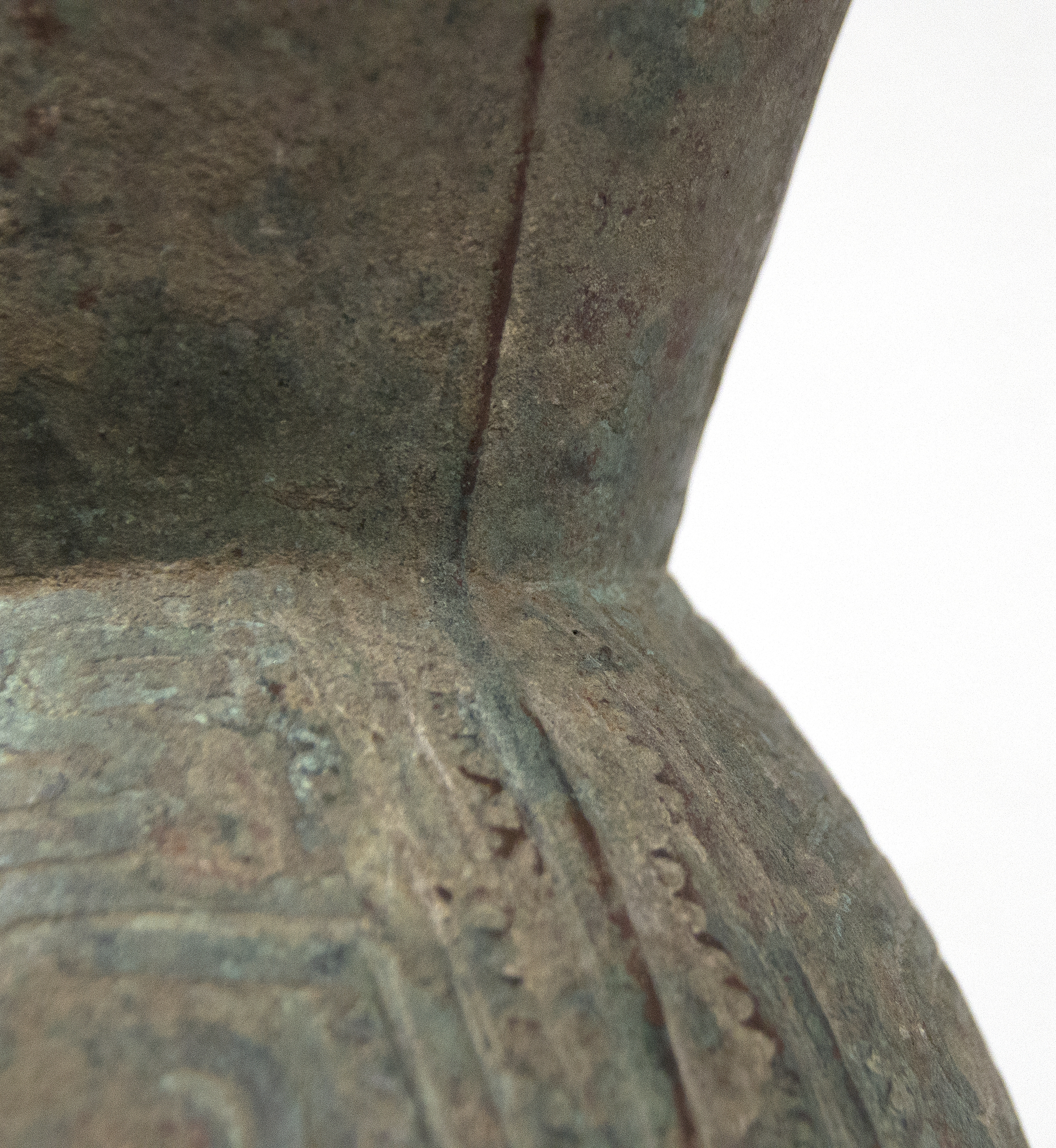 This well preserved bell is one of the largest known bronzes from the Southeast Asian Bronze Age, generally named after the Dongson site in North Vietnam.  The swirling band design is finely and crisply cast. Dongson bronze drums were also reported in South China, Thailand, Laos, West Malaysia, and Indonesia and as Far East as Western Iranian Java. 
<br>
<br>The Dong Son culture is a Bronze age culture including all of southeast Asia and into the Indo-Malaya Archipelago from about 1000 to 1 BC. Centered on the Red River Valley of Vietnam, the Dong Son were sophisticated agriculturalists, raising rice and buffalo. Dong Son probably arose from local Neolithic cultures, such as Phung Nguyen and Dong Dau phases. Dong Son is identified with the Van Lang ruling dynasty, the first ruling dynasty of Vietnam. By the second century BC, impacts from the Han Dynasty in China were being felt and according to historic records, the Dong Son were absorbed into the Han Dynasty territory.