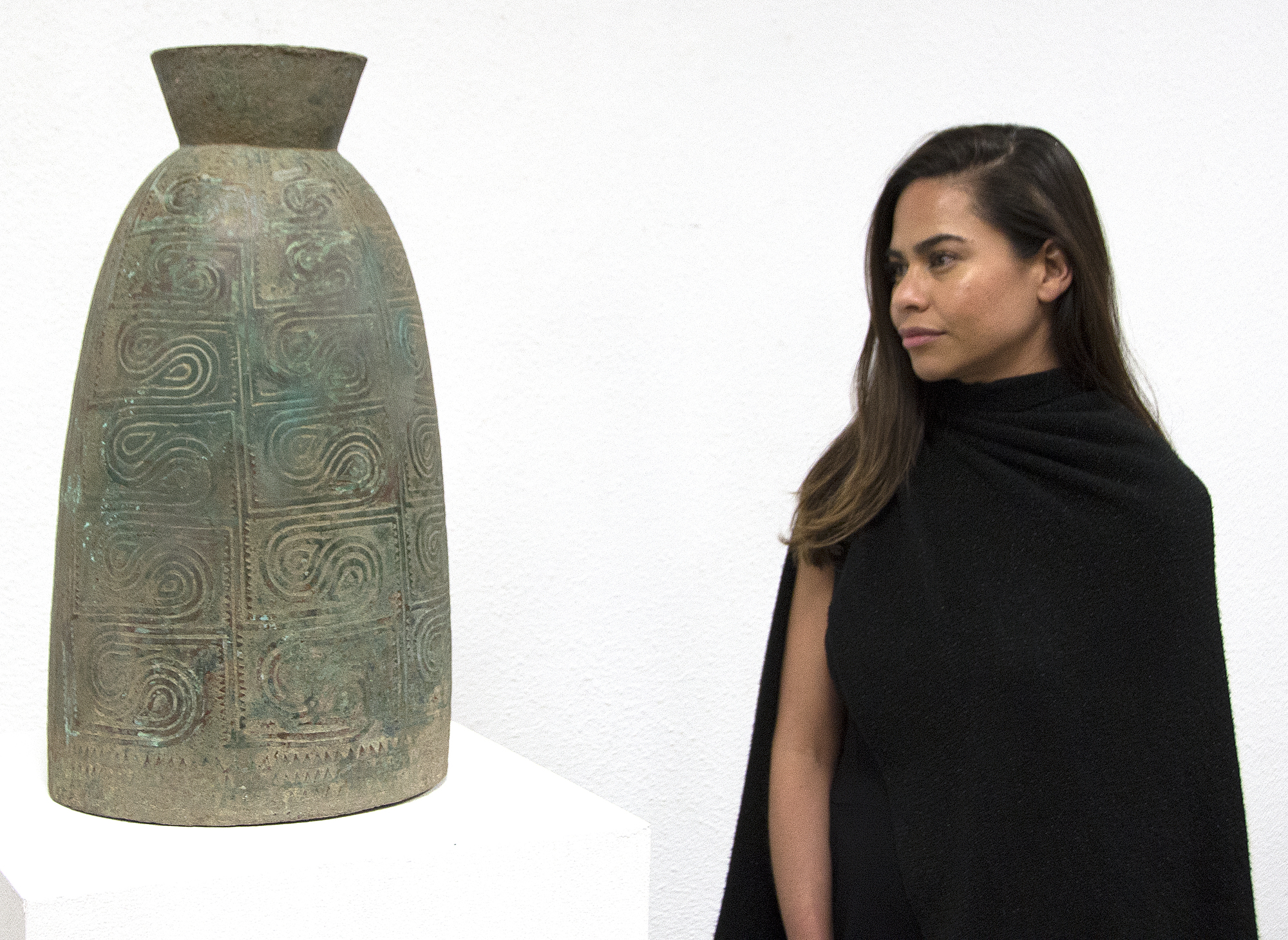 This well preserved bell is one of the largest known bronzes from the Southeast Asian Bronze Age, generally named after the Dongson site in North Vietnam.  The swirling band design is finely and crisply cast. Dongson bronze drums were also reported in South China, Thailand, Laos, West Malaysia, and Indonesia and as Far East as Western Iranian Java. 
<br>
<br>The Dong Son culture is a Bronze age culture including all of southeast Asia and into the Indo-Malaya Archipelago from about 1000 to 1 BC. Centered on the Red River Valley of Vietnam, the Dong Son were sophisticated agriculturalists, raising rice and buffalo. Dong Son probably arose from local Neolithic cultures, such as Phung Nguyen and Dong Dau phases. Dong Son is identified with the Van Lang ruling dynasty, the first ruling dynasty of Vietnam. By the second century BC, impacts from the Han Dynasty in China were being felt and according to historic records, the Dong Son were absorbed into the Han Dynasty territory.